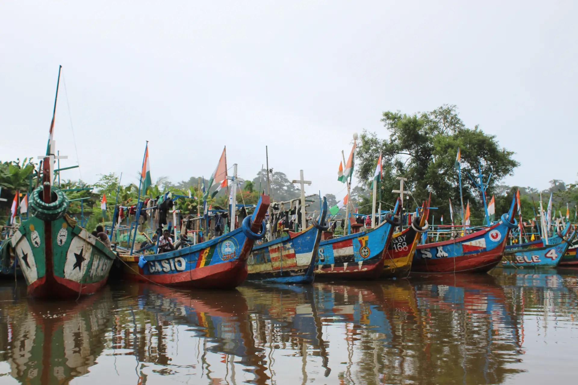 Colourful wooden fishing boats on the water in coastal Ivory Coast