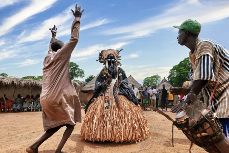 Traditional masked dance performance in a village in Ivory Coast